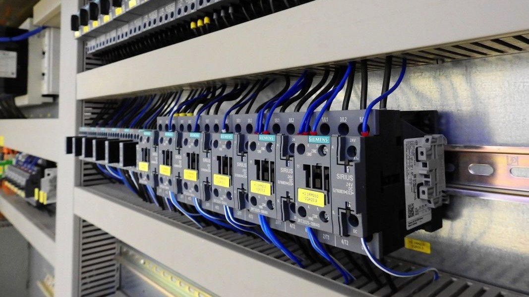 Technician analyzing HVAC control panel with building automation interface