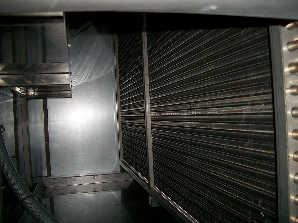 HVAC technician inspecting unit during maintenance check