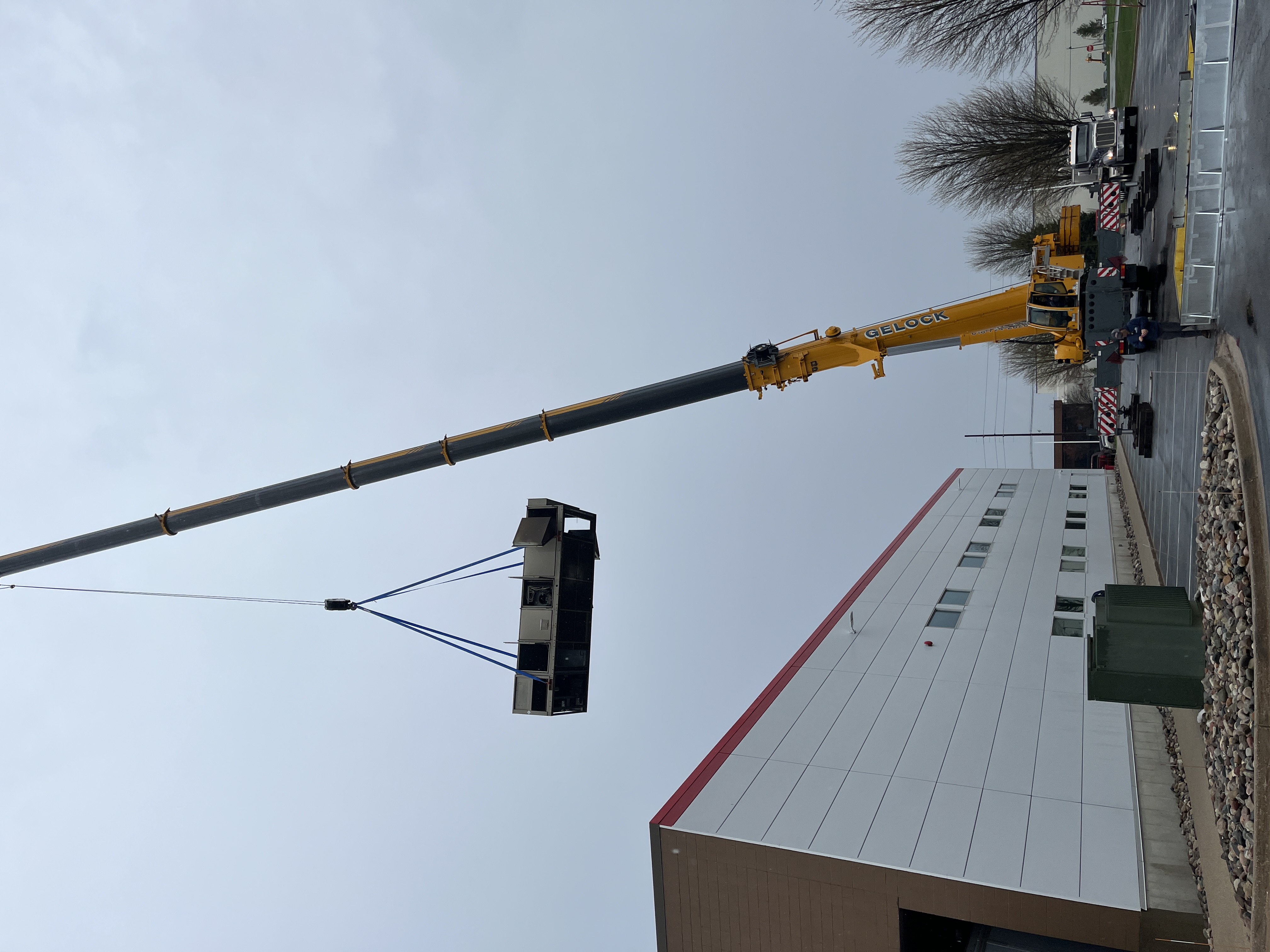Aging 30-year-old industrial rooftop HVAC unit being removed at Holland, MI metal stamping plant