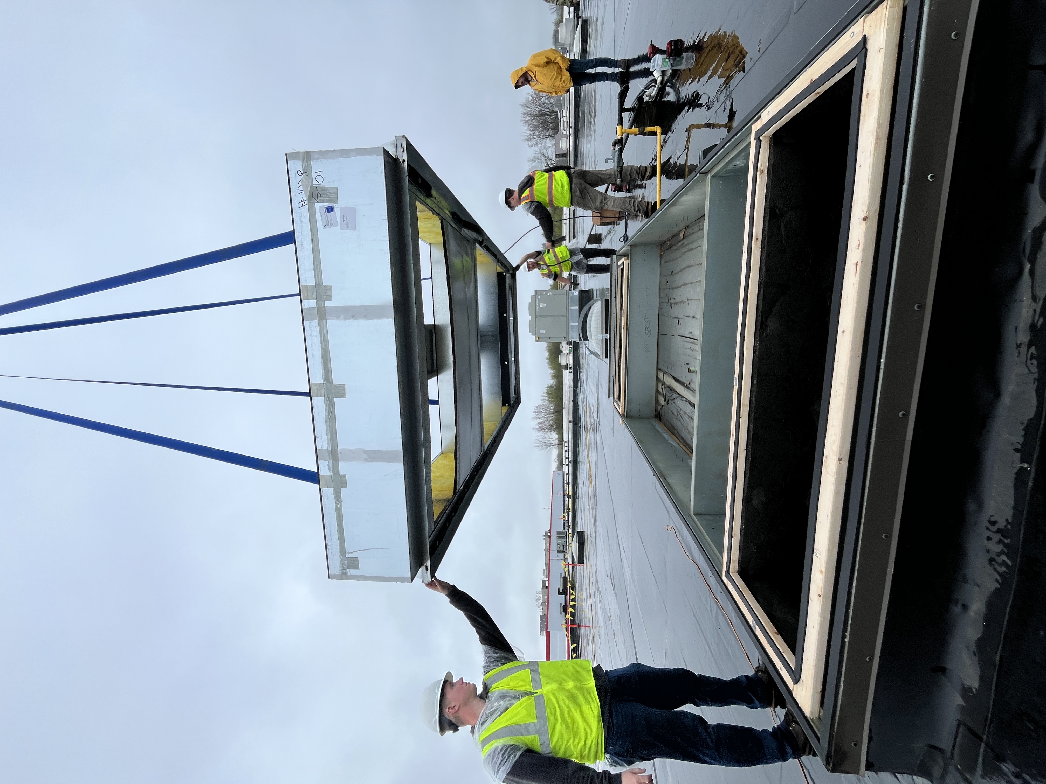 Crossroads Mechanical technician setting curb adapter for rooftop unit at Holland, MI metal stamping plant